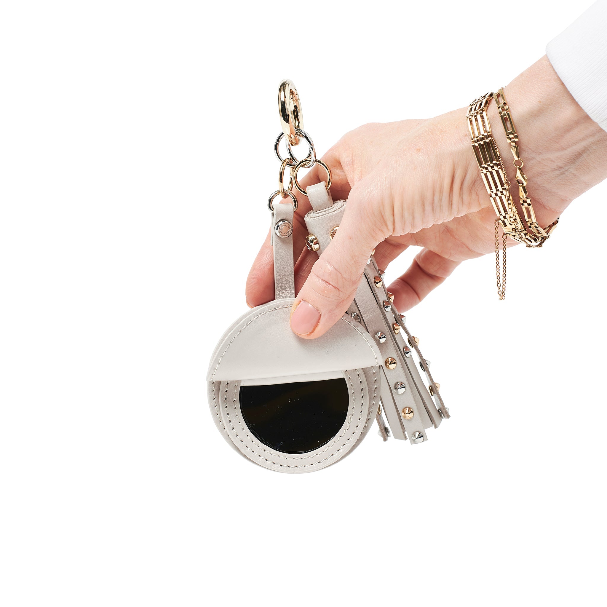 model holding warrior midi in putty studded leather showing mirror