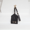 black vegan leather luggage tag and keyring with light gold hardware and personalisation on back