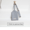dove grey leather luggage tag and keyring with light gold hardware and personalisation on back