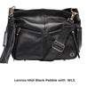 black wide leather cross body strap attached to lennox midi black baby changing bag