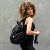 heading to gym with her amber black nylon leather backpack 