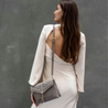 stylish woman ready for a night out with harry warm grey leather crossbody bag on shoulders using adjustable strap