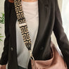 model wearing webster black camel greek symbol leather bag strap across body attached to lennox tan ladies laptop bag