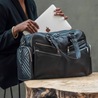model using Westwood XL weekender black leather bag as a work bag
